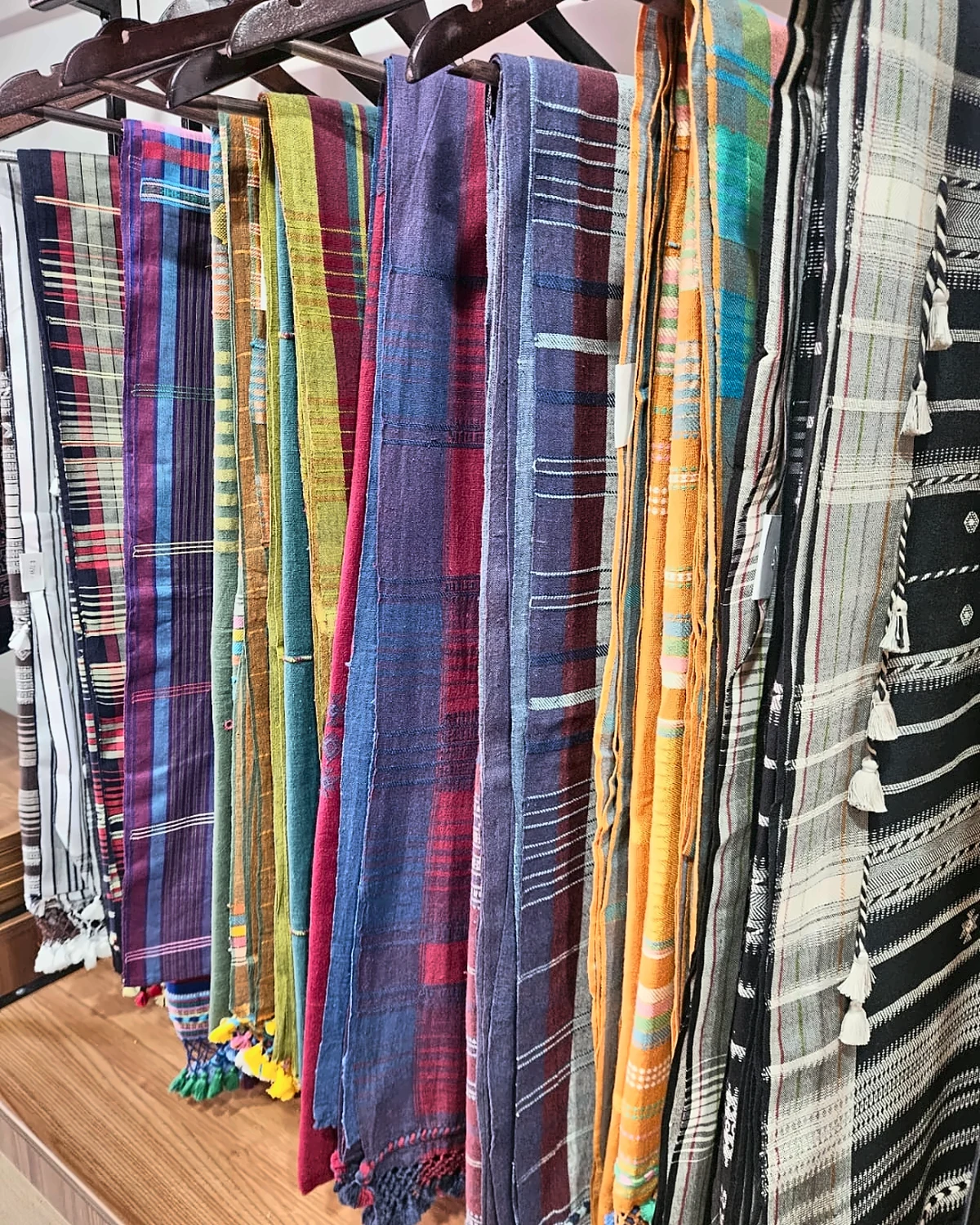 Colourful Kala cotton sarees displayed on hangers inside the Sutra Kalaa studio